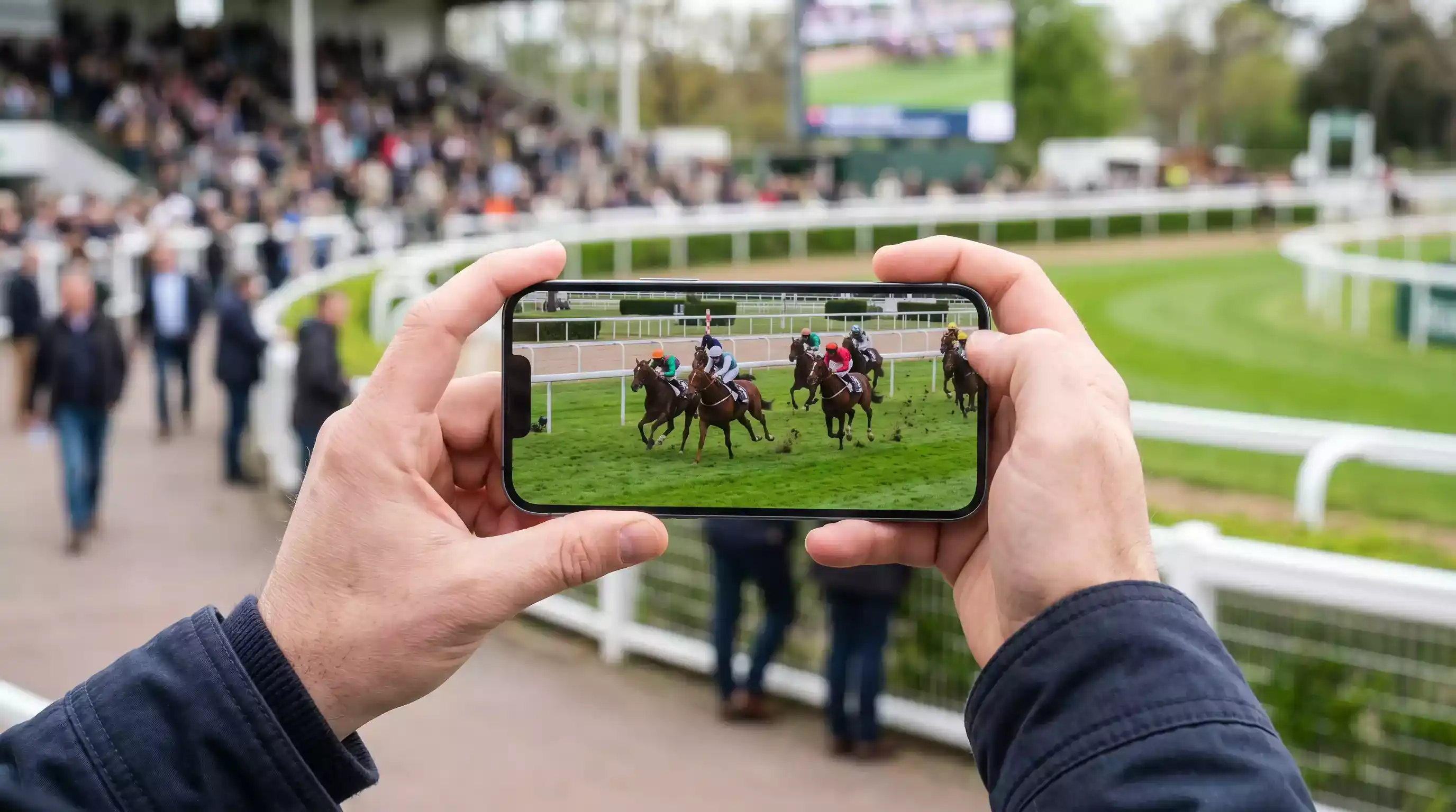 Live horse racing streaming on mobile device at UK racecourse